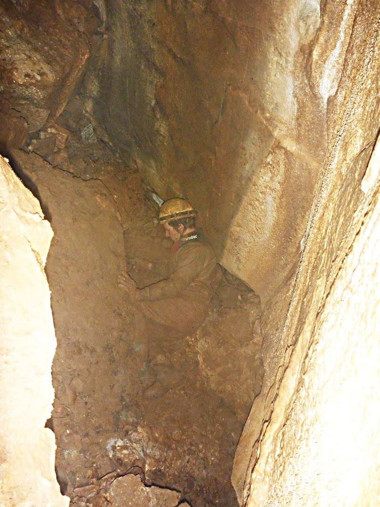 A newly discovered cave passage with a strong draft.