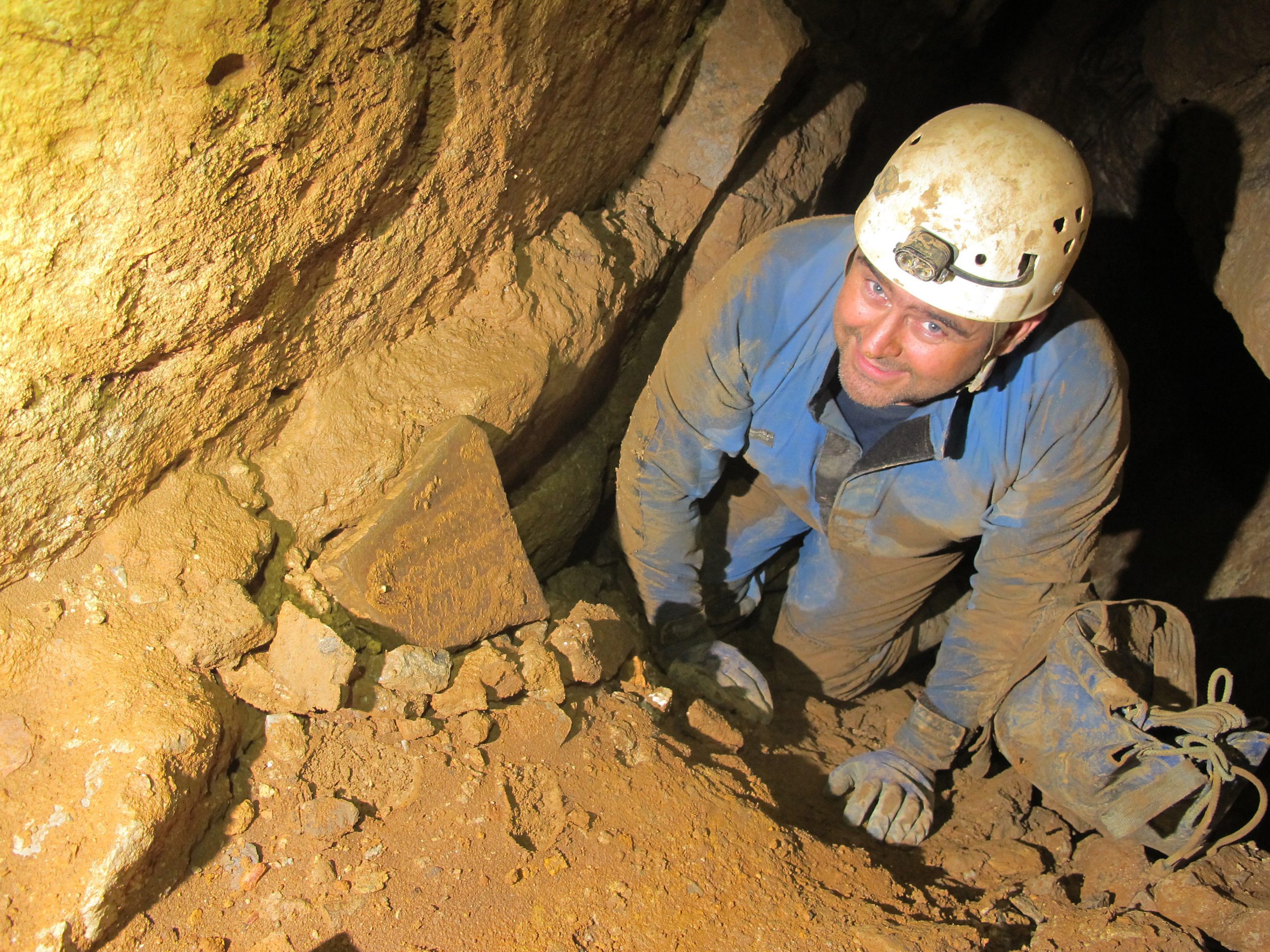 A caver in a small passage