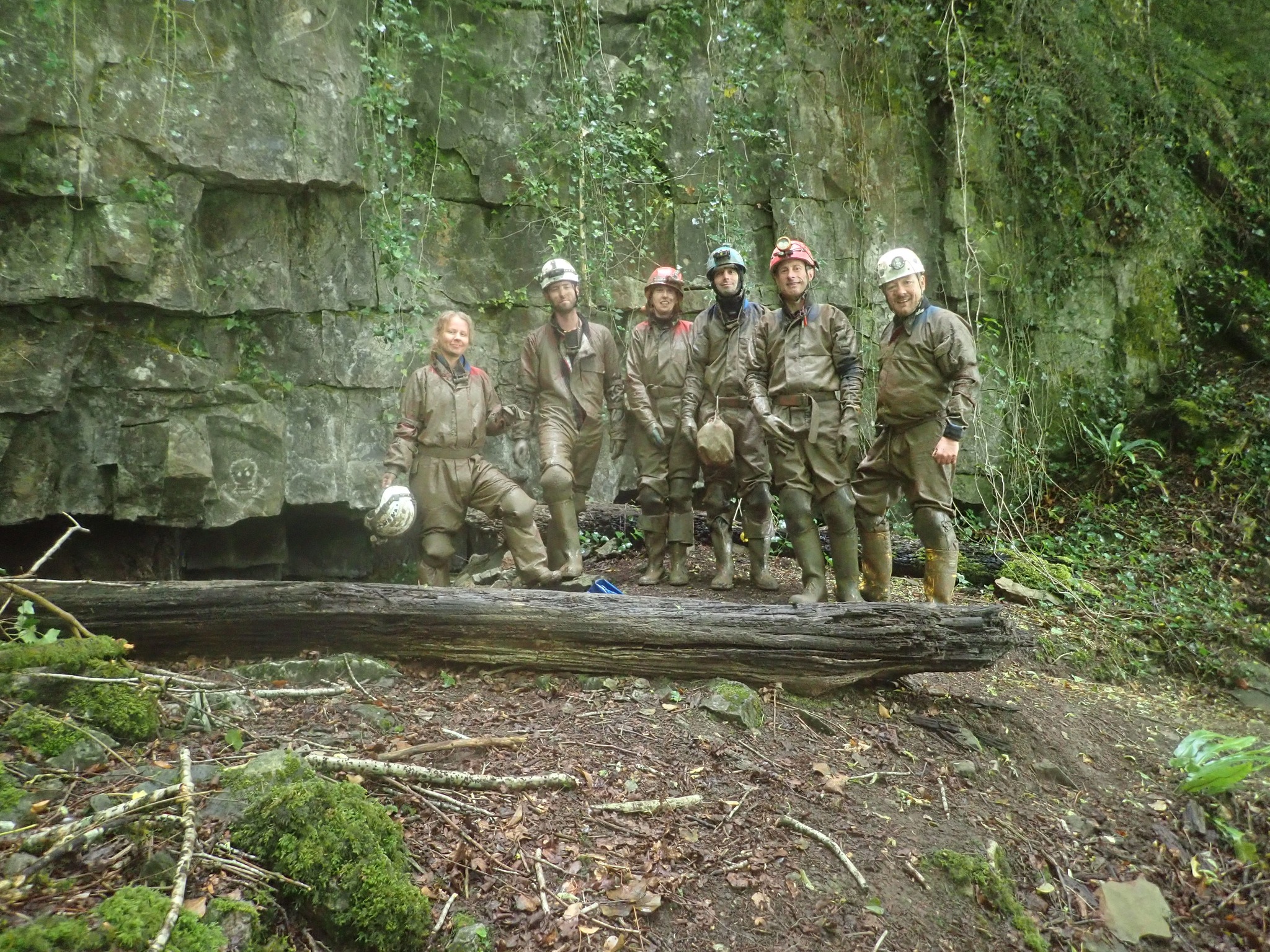 Group of Muddy Cavers outside the entrance