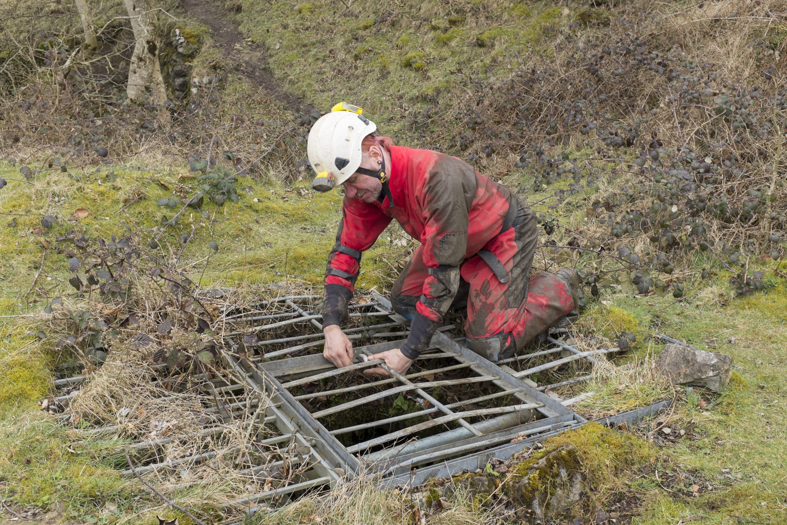 The Gated Shaft entrance with a caver unlocking it.